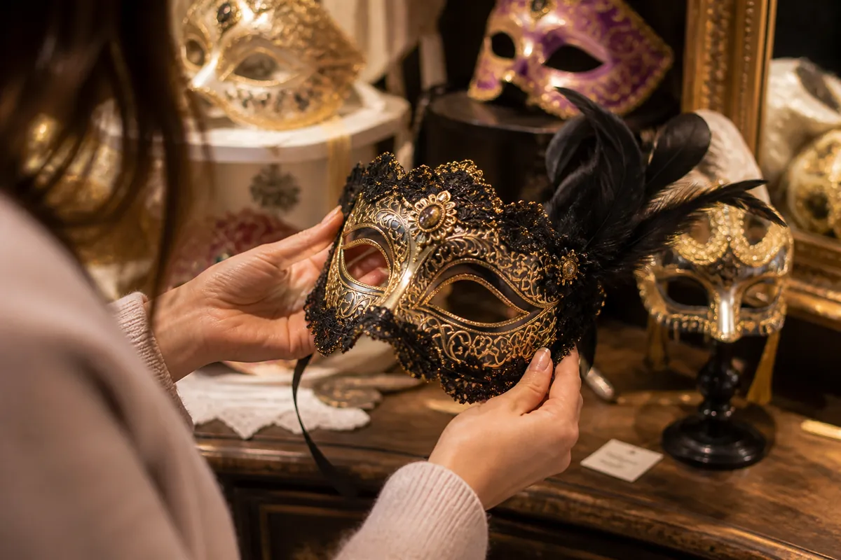 Person selecting a decorative masquerade mask