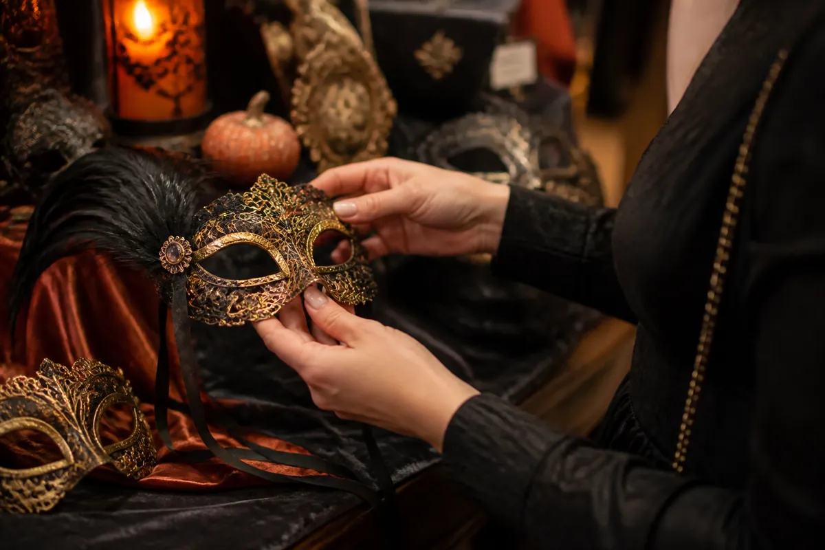 Person selecting a decorative masquerade mask